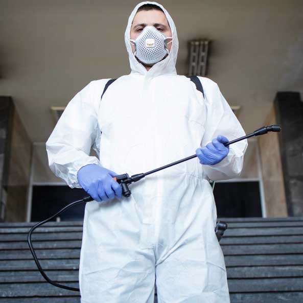 man spraying mold treatment  for remediation